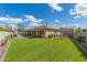 Large backyard featuring artificial turf, a covered patio, a built-in grill, and ample space for outdoor entertaining at 104 E Louis Way, Tempe, AZ 85284