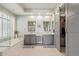 Large bathroom with double sinks, a sliding door to the walk-in closet, and a soaking tub at 104 E Louis Way, Tempe, AZ 85284