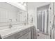 Bright bathroom featuring double sinks, neutral wall color, and an enclosed shower at 104 E Louis Way, Tempe, AZ 85284