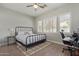 Bedroom with metal frame bed and a workspace near a window with shutters at 104 E Louis Way, Tempe, AZ 85284