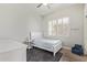 Bedroom features a white bed and decor with a window and natural light at 104 E Louis Way, Tempe, AZ 85284