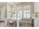 Cozy breakfast nook with a white table and modern chairs, illuminated by stylish pendant lighting at 104 E Louis Way, Tempe, AZ 85284