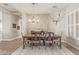 The dining room features a wood table with six chairs, a chandelier, and an animal skull on the wall at 104 E Louis Way, Tempe, AZ 85284