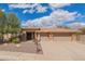 Beautiful single-story home with a tile roof, desert landscaping and a spacious three car garage with brick detailing at 104 E Louis Way, Tempe, AZ 85284