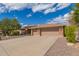 Beautiful single-story home with a tile roof, desert landscaping and a spacious three car garage with brick detailing at 104 E Louis Way, Tempe, AZ 85284