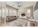 Relaxing living room with plush sofa, ceiling fan, and large windows offering ample natural light at 104 E Louis Way, Tempe, AZ 85284