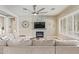 Modern living room showcasing a stone fireplace, large sectional sofa, and contemporary decor, creating a comfortable gathering space at 104 E Louis Way, Tempe, AZ 85284
