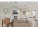Comfortable living room featuring a cozy fireplace, plush sectional sofa, and plenty of natural light from plantation shutters at 104 E Louis Way, Tempe, AZ 85284