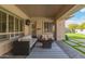 Covered patio area with wicker seating, outdoor rug, and fire pit, perfect for relaxation at 104 E Louis Way, Tempe, AZ 85284