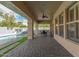 Spacious covered patio with brick flooring, ceiling fan, and outdoor dining area near the pool at 104 E Louis Way, Tempe, AZ 85284