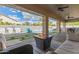 Inviting covered patio with cozy seating, fire pit, and view of the sparkling pool at 104 E Louis Way, Tempe, AZ 85284