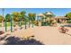 Well-equipped playground offering swings, slides, and various play structures in a sand-filled area, promoting active play at 104 E Louis Way, Tempe, AZ 85284
