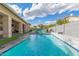 Beautiful backyard pool with a waterfall feature and covered patio area, ideal for outdoor enjoyment at 104 E Louis Way, Tempe, AZ 85284
