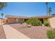 Well-maintained backyard featuring low-maintenance landscaping, covered patio, and mature trees at 1156 E Brenda Dr, Casa Grande, AZ 85122