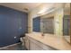 Bathroom featuring a large mirror, a single sink vanity, and a walk-in shower with glass door at 1156 E Brenda Dr, Casa Grande, AZ 85122