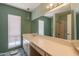 Bathroom features a large mirror, a single sink vanity, and a walk-in shower with glass door at 1156 E Brenda Dr, Casa Grande, AZ 85122