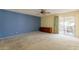 Spacious bedroom featuring a ceiling fan, an accent wall, and sliding glass doors to the outside patio at 1156 E Brenda Dr, Casa Grande, AZ 85122