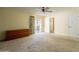 Bright bedroom boasts neutral tones, a ceiling fan, and a sliding glass door leading to an outdoor patio at 1156 E Brenda Dr, Casa Grande, AZ 85122