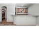 Dry bar featuring granite counters, wood cabinets, and access to another room at 11785 N 143Rd Dr, Surprise, AZ 85379