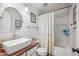 Modern bathroom with white shiplap, wood countertop, vessel sink and a ruffled shower curtain at 11785 N 143Rd Dr, Surprise, AZ 85379