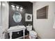 Charming powder room featuring a pedestal sink, shiplap wall, and modern lighting at 11785 N 143Rd Dr, Surprise, AZ 85379