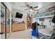 Bedroom boasts a ceiling fan, dresser with television, shelving, and a bunk bed at 11785 N 143Rd Dr, Surprise, AZ 85379