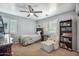 Bedroom with neutral paint, carpet flooring, ceiling fan, plantation shutters, and reading nook at 11785 N 143Rd Dr, Surprise, AZ 85379