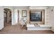Cozy bedroom with fireplace, built-in shelves, and a view into the hallway at 11785 N 143Rd Dr, Surprise, AZ 85379