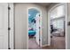 Arched doorway between hallway and bedroom with sitting area featuring plush chair and decor at 11785 N 143Rd Dr, Surprise, AZ 85379