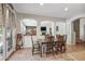 Open-concept dining area featuring wood table and views to the patio and Gathering room at 11785 N 143Rd Dr, Surprise, AZ 85379