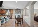 Open-concept dining area with tile floors, wood table with seating for six, and views to the pool at 11785 N 143Rd Dr, Surprise, AZ 85379
