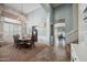 Dining room with chandelier, wainscoting, and staircase access at 11785 N 143Rd Dr, Surprise, AZ 85379