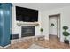 Stone fireplace with a black screen, a white mantel, shiplap, and a TV above it in the living room at 11785 N 143Rd Dr, Surprise, AZ 85379