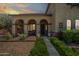 Inviting front porch with arched columns, stone accents, and comfortable seating area at 11785 N 143Rd Dr, Surprise, AZ 85379