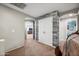 Neutral hallway featuring arched doorways and a wood accent wall by the closet at 11785 N 143Rd Dr, Surprise, AZ 85379