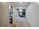 Bright hallway with doors leading to an adjacent living room and another room, all with light carpeting at 11785 N 143Rd Dr, Surprise, AZ 85379