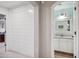 Hallway view showing white shiplap wall with entry to a bathroom featuring bright vanity and light blue walls at 11785 N 143Rd Dr, Surprise, AZ 85379
