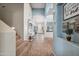 Hallway with carpeting on the stairs, arched openings, and an ornate console table and decor at 11785 N 143Rd Dr, Surprise, AZ 85379