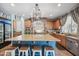 This beautiful kitchen includes light blue accents, a stone hood over the oven, and large island at 11785 N 143Rd Dr, Surprise, AZ 85379