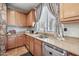 Kitchen features wood cabinets, granite countertops, stainless steel appliances, and a breakfast bar at 11785 N 143Rd Dr, Surprise, AZ 85379