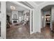Open-concept living room with fireplace, wainscoting and chandelier at 11785 N 143Rd Dr, Surprise, AZ 85379
