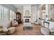 Cozy living room featuring a fireplace, a wooden cabinet, and natural lighting at 11785 N 143Rd Dr, Surprise, AZ 85379