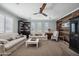 Cozy living room featuring sofas, a wooden ceiling fan, and tile flooring at 11785 N 143Rd Dr, Surprise, AZ 85379