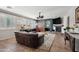 The comfortable living room features tile floors, a fireplace, and access to another room with a rustic barn door at 11785 N 143Rd Dr, Surprise, AZ 85379