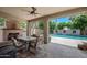 Outdoor patio with large table and chairs, fireplace, and view of the swimming pool at 11785 N 143Rd Dr, Surprise, AZ 85379