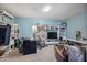 A neutral carpeted room with light blue walls features a TV, a desk and plenty of storage shelving at 11785 N 143Rd Dr, Surprise, AZ 85379