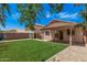 The backyard includes an outdoor covered patio, artificial turf, and rock landscaping at 12109 N 127Th Dr, El Mirage, AZ 85335