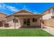 The backyard includes an outdoor covered patio, artificial turf, and rock landscaping at 12109 N 127Th Dr, El Mirage, AZ 85335