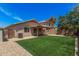 The backyard features a covered patio, artificial turf, and easy to maintain rock landscaping at 12109 N 127Th Dr, El Mirage, AZ 85335