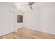 Bedroom featuring a closet, window with blinds, wood-look flooring and neutral paint at 12109 N 127Th Dr, El Mirage, AZ 85335